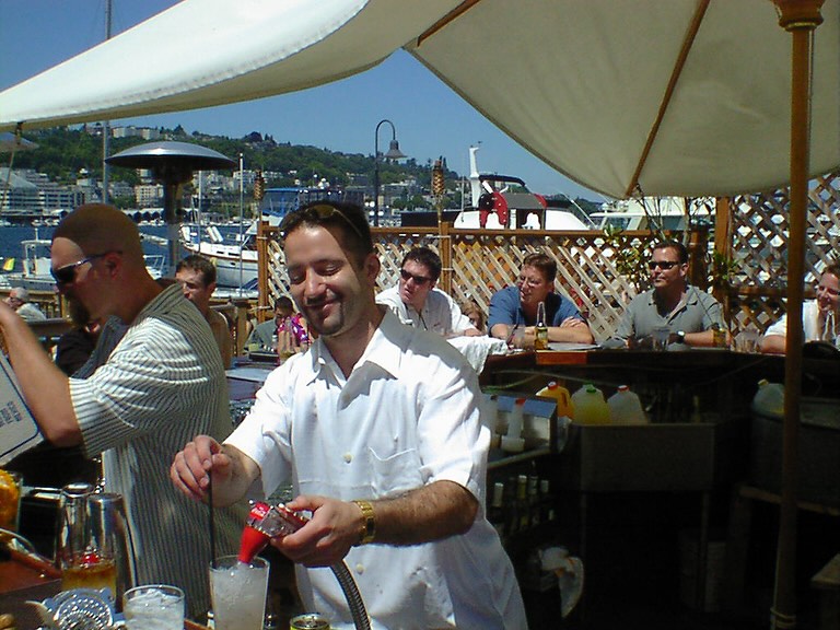Server pouring drinks on the patio